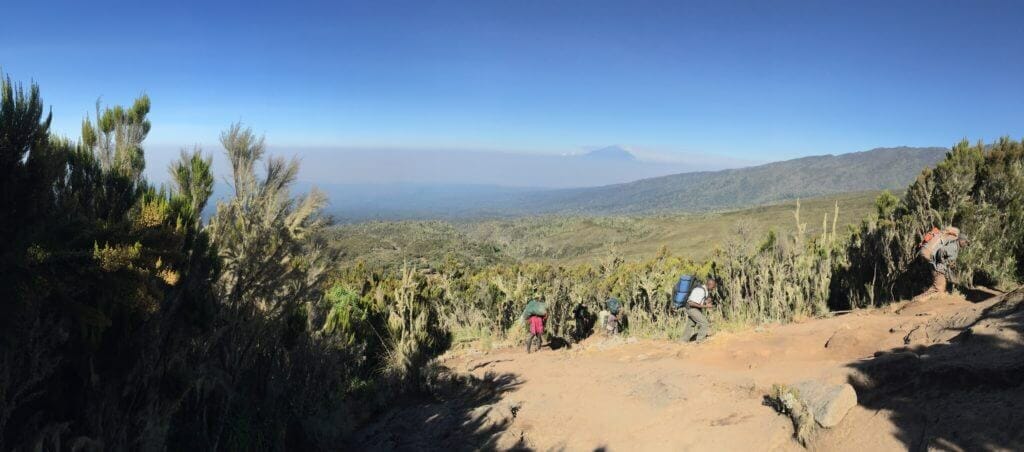 Two of our guides looking over me as I look back towards Machame Camp